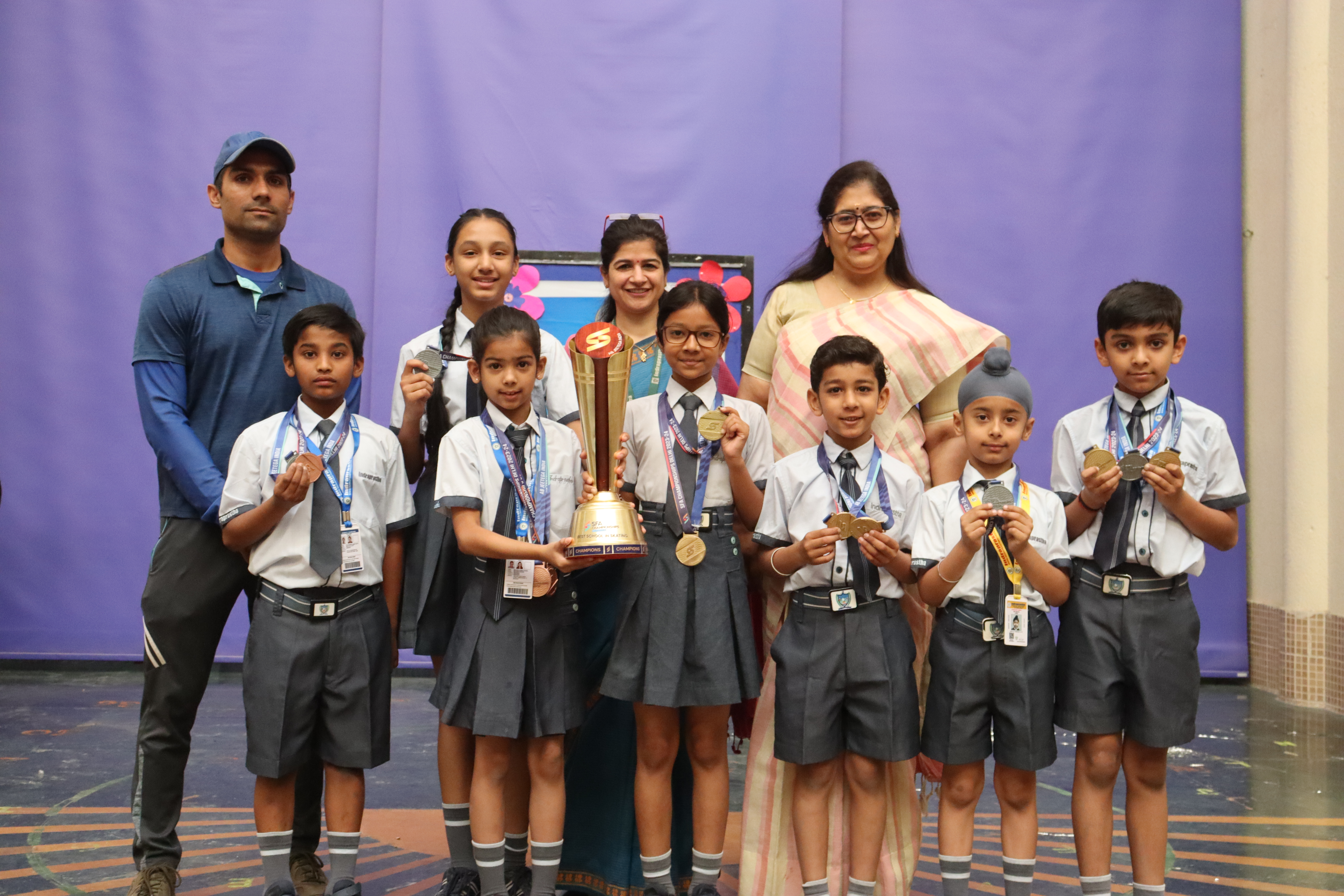 Students holding up their winning trophy, beaming with pride.
